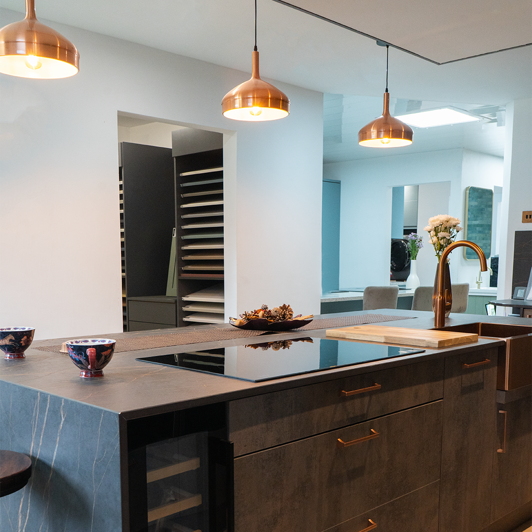 Dark bronze island with copper pendants