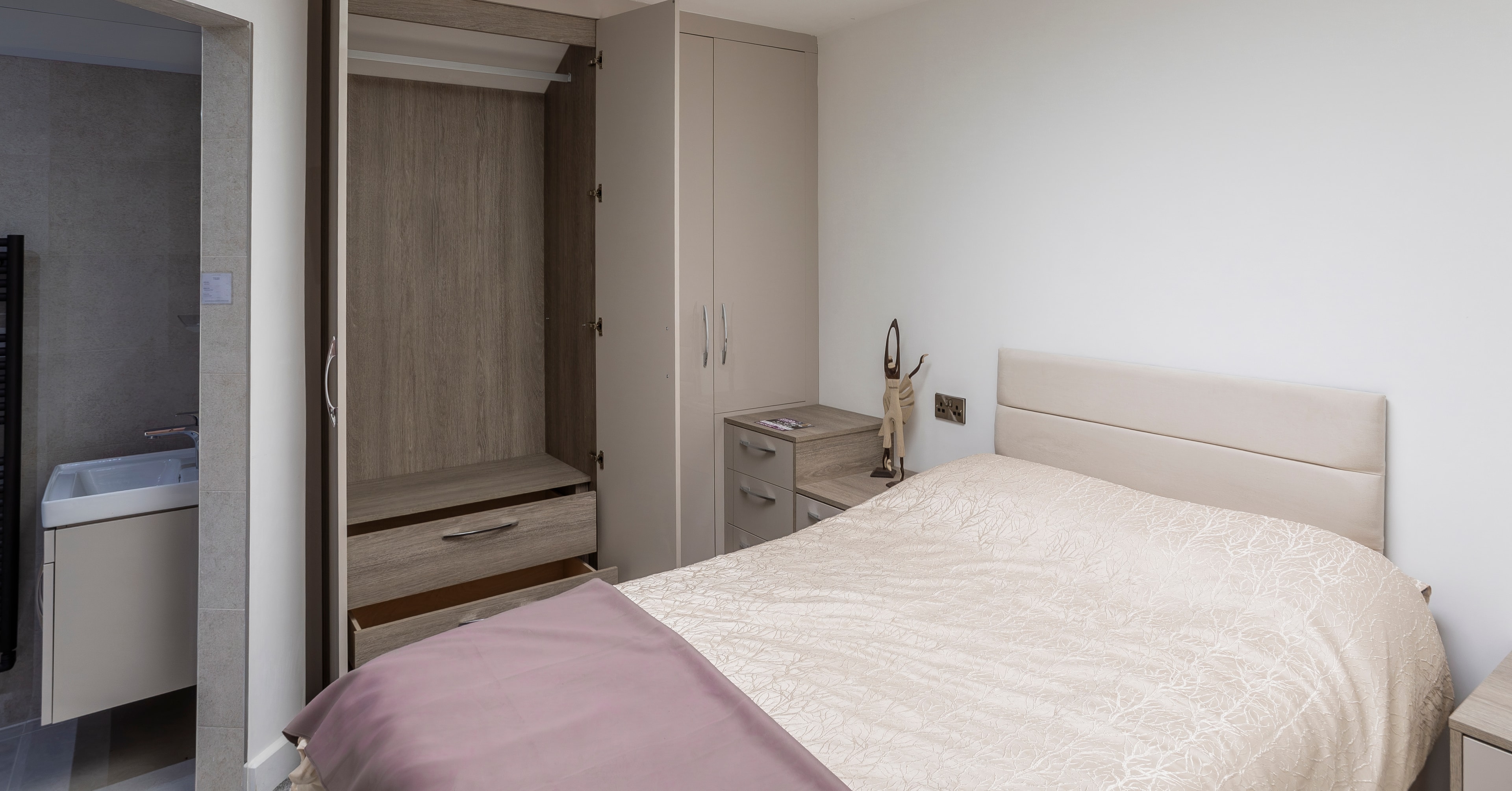 Pastel grey bedroom with pink accents